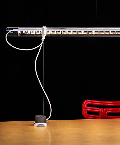 ingo maurer's 'tubular balance' is a hybrid between a pendant light and a table lamp