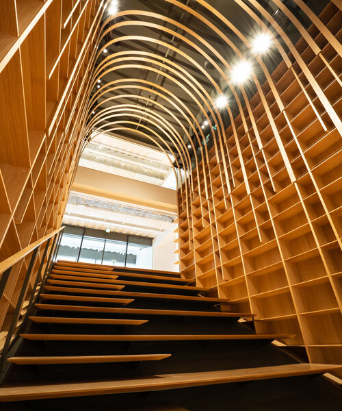 kengo kuma designs a wooden tunnel for the haruki murakami library in tokyo