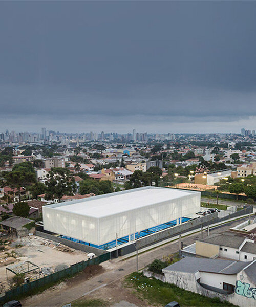 new sports pavilion in brazil takes shape as a suspended box that lights up at night