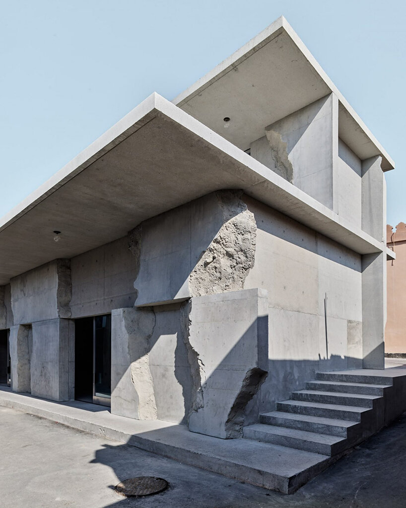 sand-casted concrete façade clads anne holtrop's green corner building in  bahrain