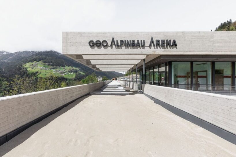 alleswirdgut's new community center in austria hovers over land as two suspended planes