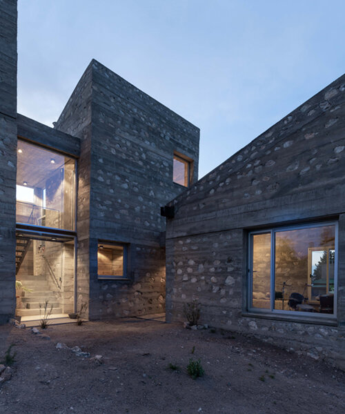 nanzer | vitas echoes a ruinous fortress in argentina with its stone-clad casa DP