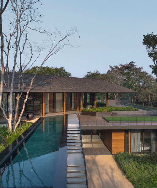 thailand-based architects 49 integrates its diagonal house into the forested landscape