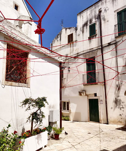gabriele mundula highlights the depopulation of rural italy with an installation of red ropes