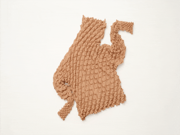 issey miyake's wool shell knit swirls like a seashell