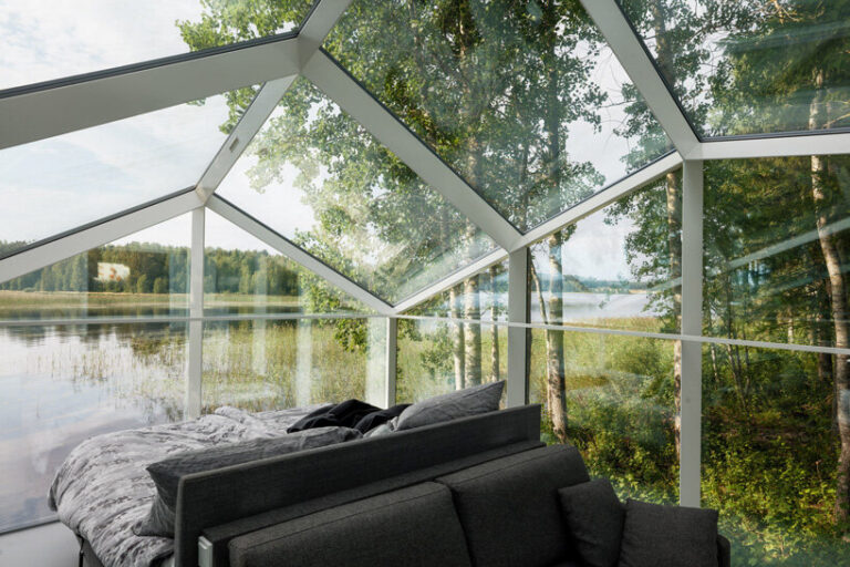 mirrored glass cabin with panoramic views disappears into finland's ...