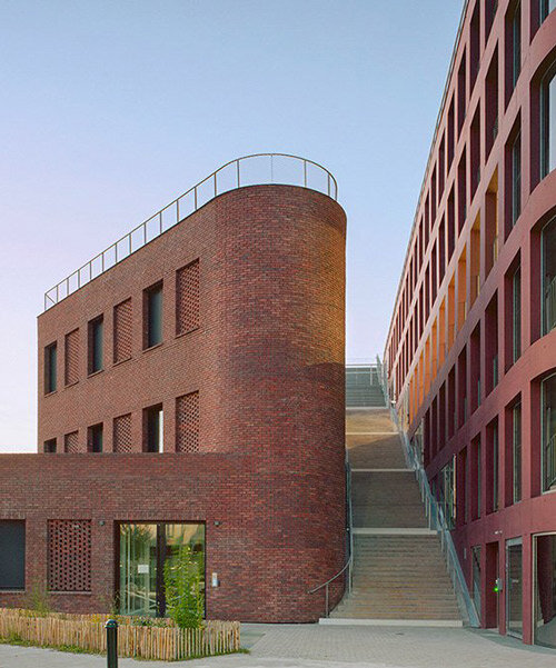 red brick and colored concrete unify raum’s mixed-use building in nantes
