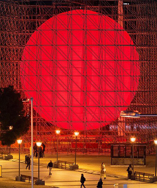 SpY cages huge luminous red sphere within scaffolding structure in madrid