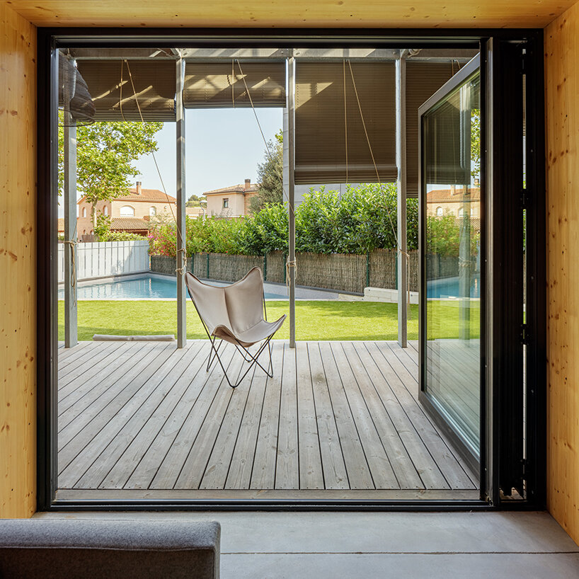 outside barcelona, SUMO architects wraps its BE house in an operable shading system