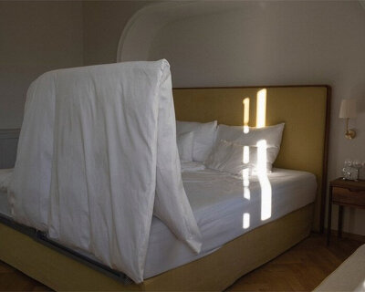 'AIRZAG' is a minimalist bed accessory that helps you air your covers quickly and easily