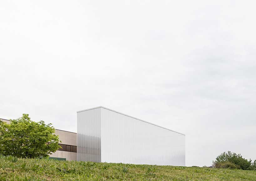 this automated warehouse in italy oscillates between opacity and transparency