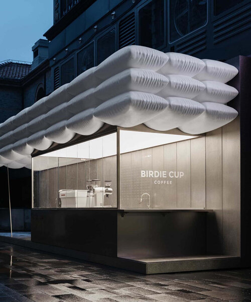 F.O.G. architecture's birdie cup coffee is nested beneath a roof of floating white puffs