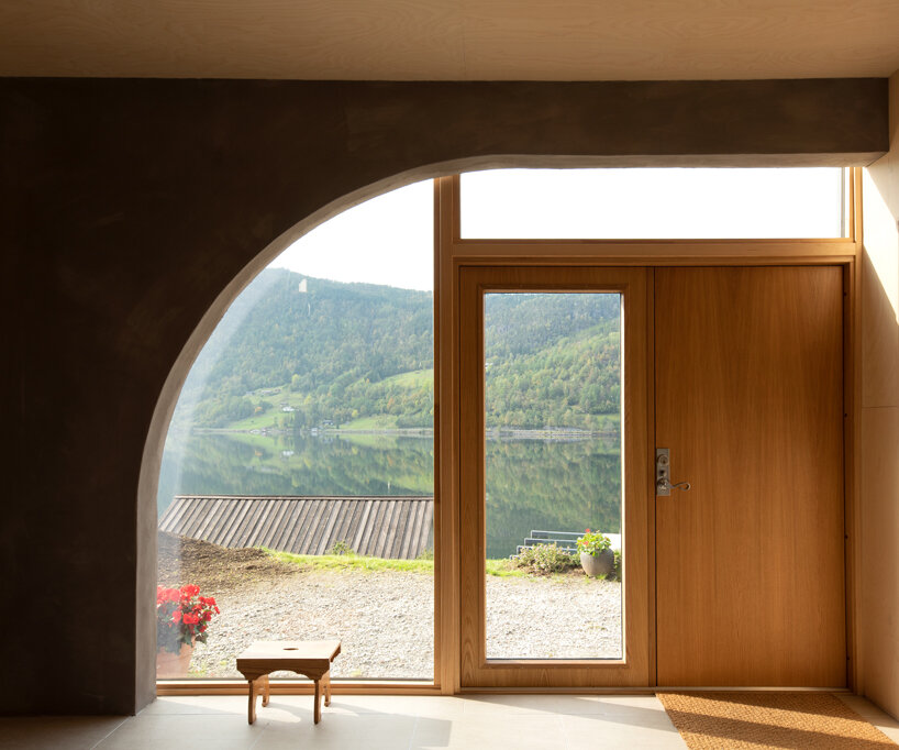 a slanted beam supports this fjord-side cabin in western norway