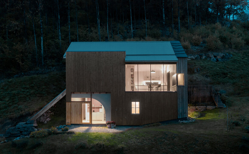 a slanted beam supports this fjord-side cabin in western norway