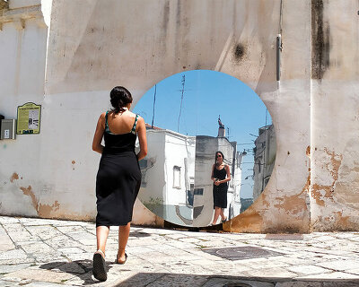 circular reflective installation by studio sifr reinvents urban perception in noci, italy