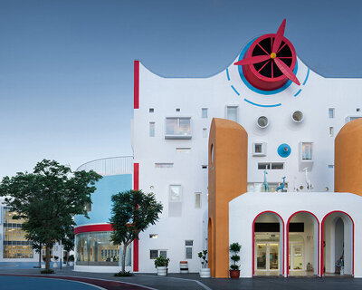 dika design attaches playful red propeller to the top of 'paper airplane' kindergarten in china