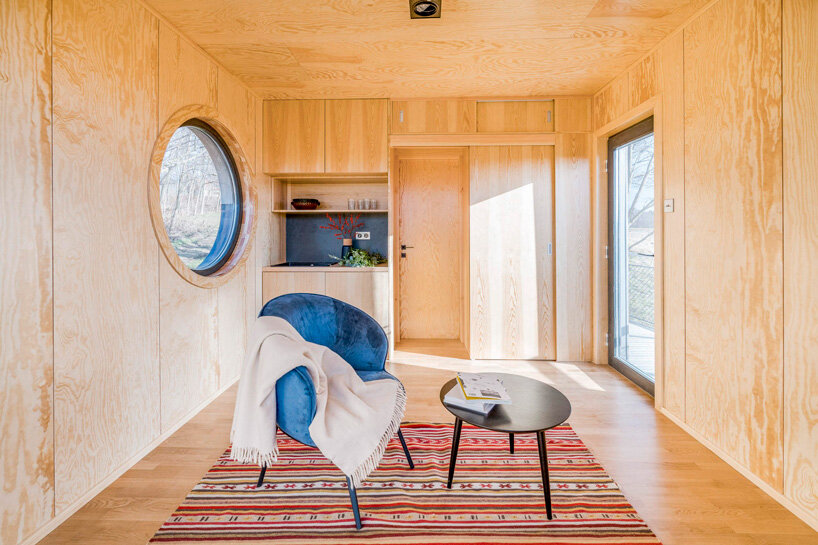 hello wood elevates wauhaus cabin on legs of different lengths in hungary