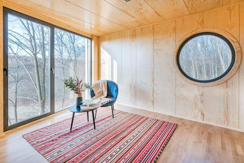 hello wood elevates wauhaus cabin on legs of different lengths in hungary