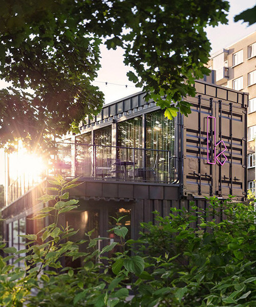COLLARCH shapes café from gray recycled shipping containers in prague