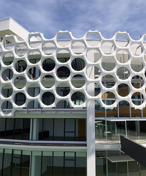 jewel-like façade of 4,000 double curve components enclose orange côte d’ivoire HQ
