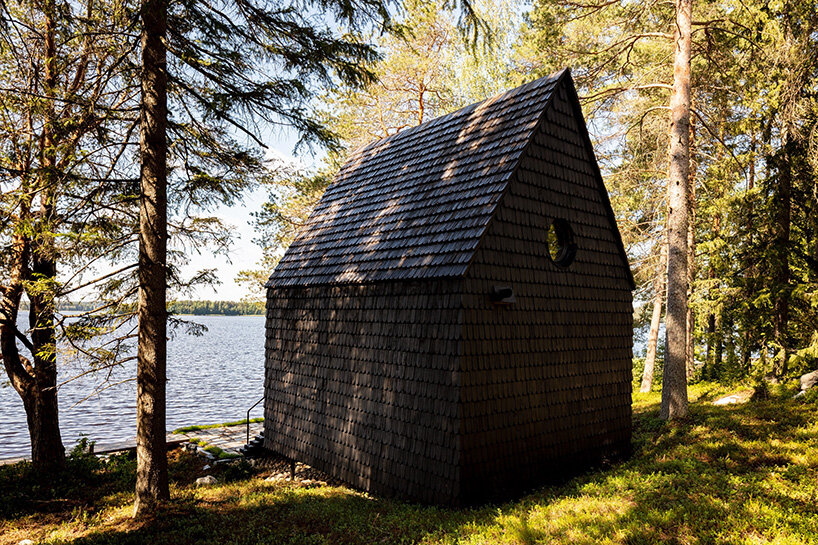 pirinen & salo clad the filmmakers hut in finland with tar-coated shingles