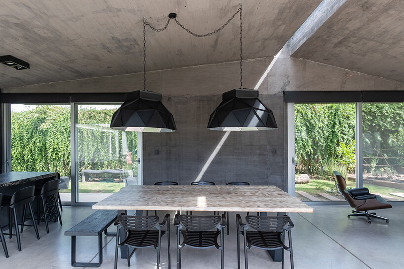 a thin ray of light permanently pierces through this argentinian house