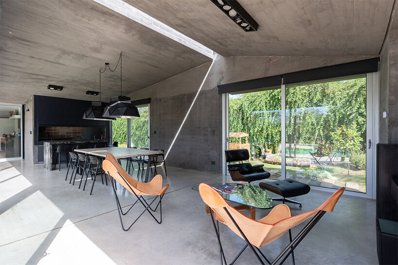 a thin ray of light permanently pierces through this argentinian house