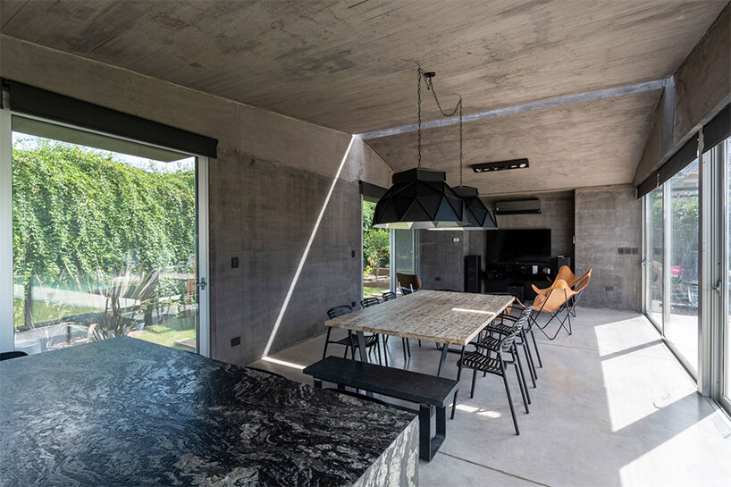 a thin ray of light permanently pierces through this argentinian house