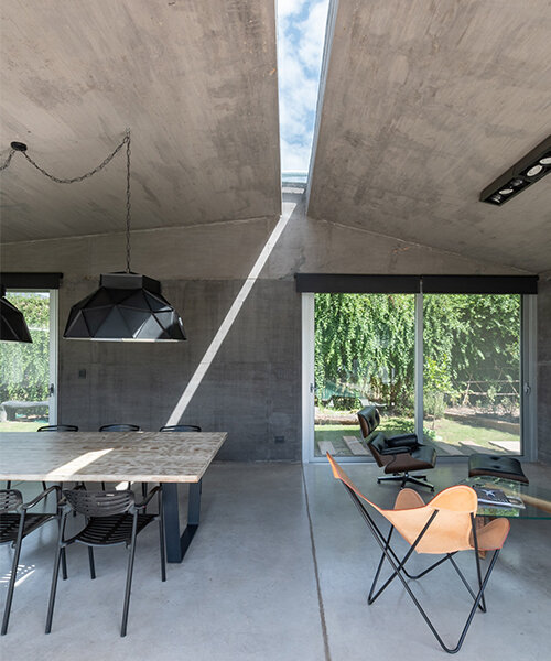 a thin ray of light permanently pierces through this argentinian house