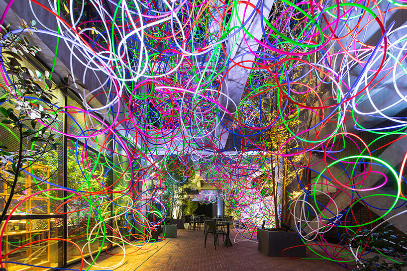 kengo kito fills sou fujimoto-designed shiroiya hotel with 2,500 illuminated festive hula hoops