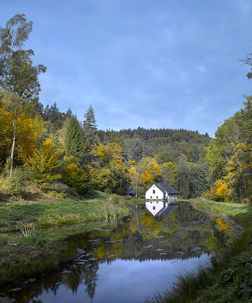 restored century-old mill splits into a home in czech republic's green ponds