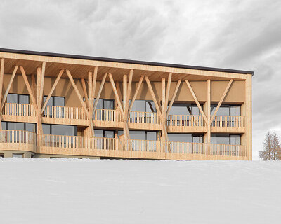 MoDusArchitects unveils its icaro hotel, a forest of timber columns in the dolomites