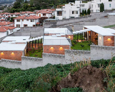 three interconnected staggered blocks shape house on slope in ecuador