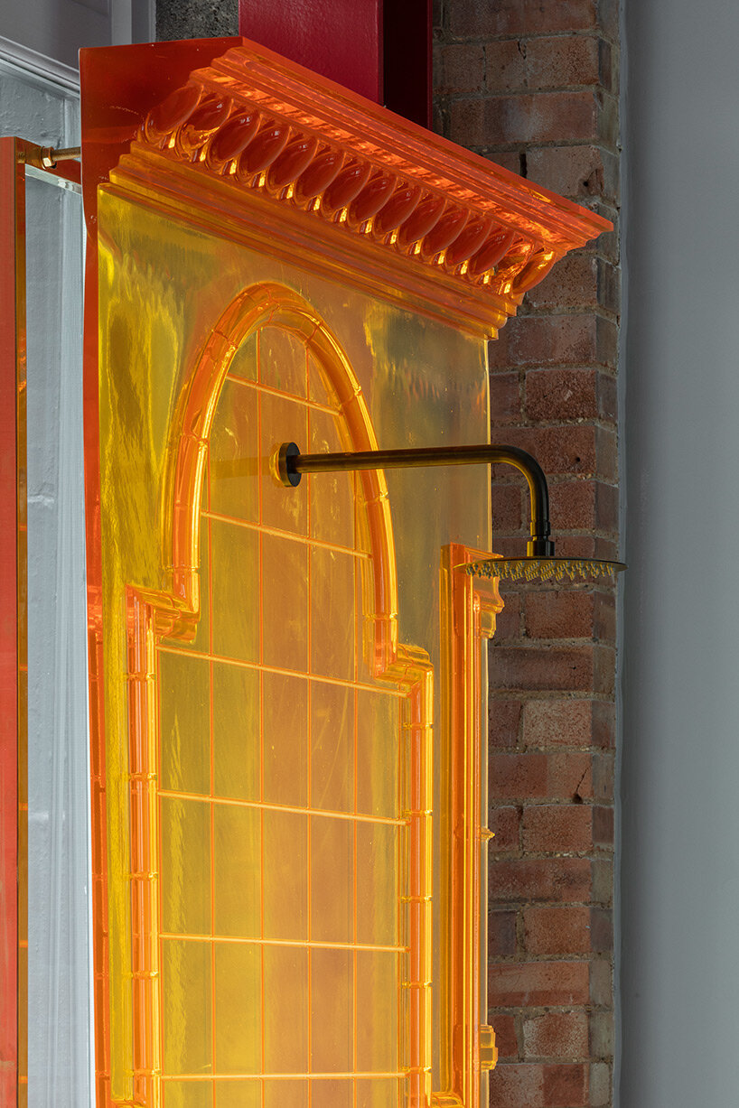 chimneys, boilers and brightly colored resin panels complete london showroom by holloway li