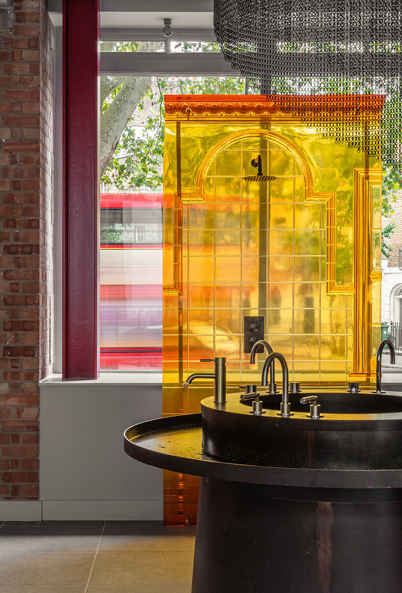 chimneys, boilers and brightly colored resin panels complete london showroom by holloway li