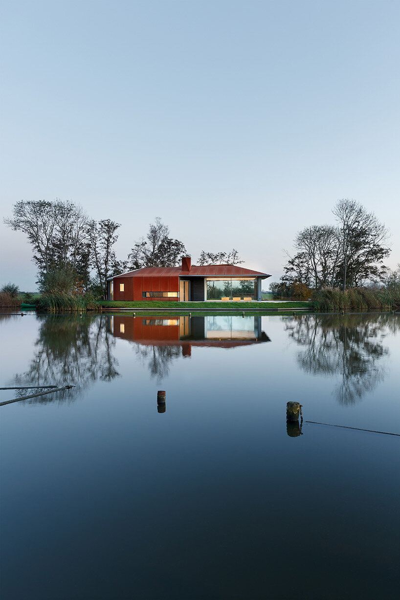 rural house that prioritizes natural lighting settles amid polder landscape in the netherlands