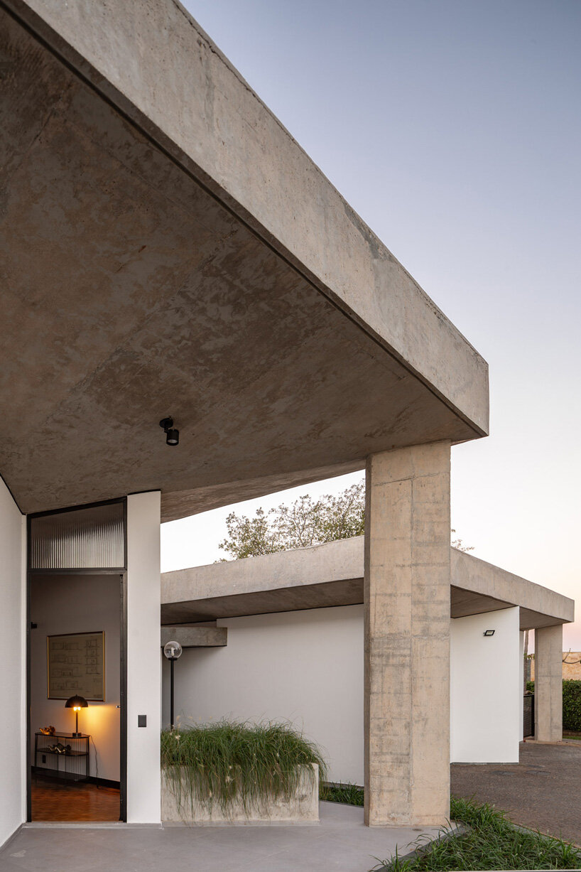 concrete pillars define movement in debaixo do bloco's brutalist 'section house' in brazil