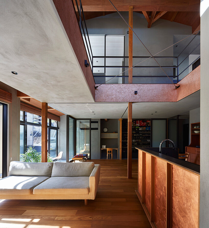 a double height void cuts through this house in japan