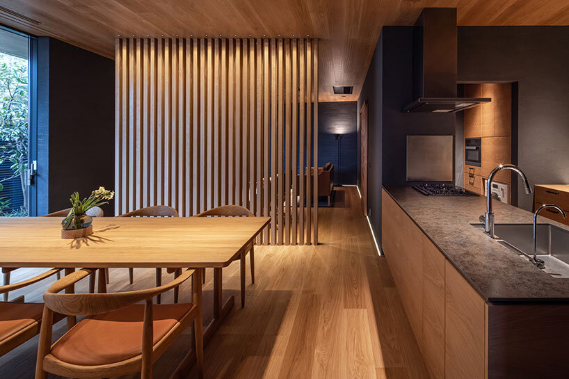 kawazoe architects binds three buildings into a home with a curved path in japan