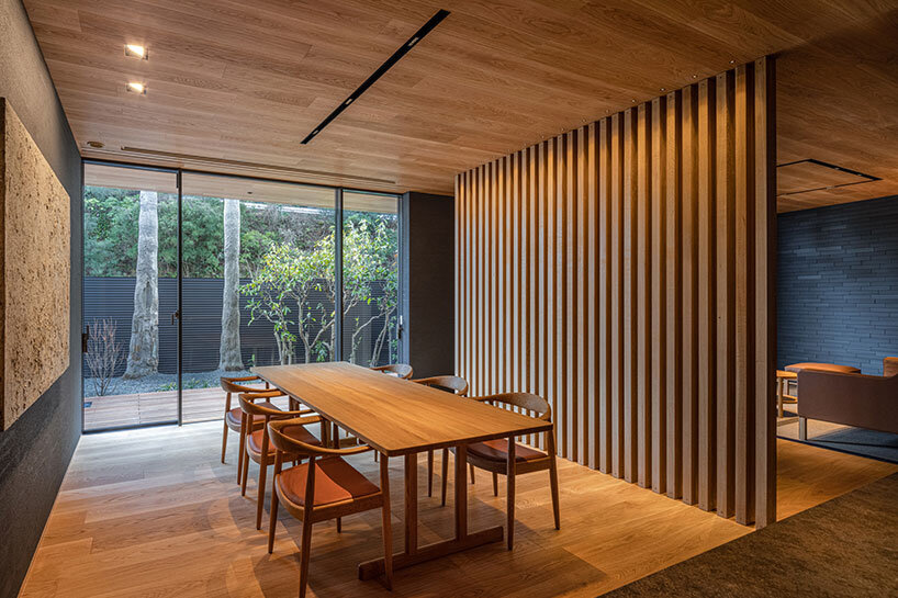kawazoe architects binds three buildings into a home with a curved path in japan