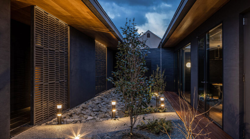 kawazoe architects binds three buildings into a home with a curved path in japan