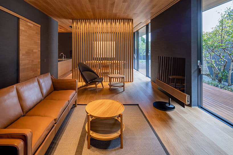 kawazoe architects binds three buildings into a home with a curved path in japan