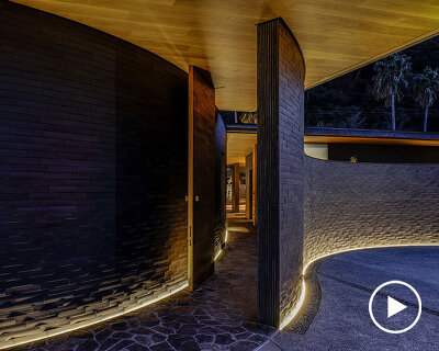 kawazoe architects binds three buildings into a home with a curved path in japan