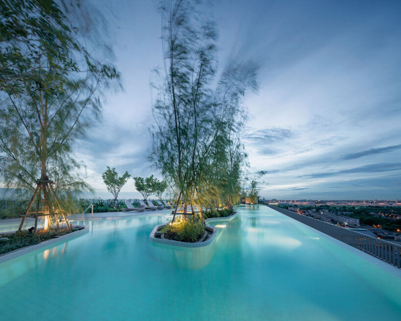 openbox architects inserts rose gold spiral ramp between two residential towers in bangkok