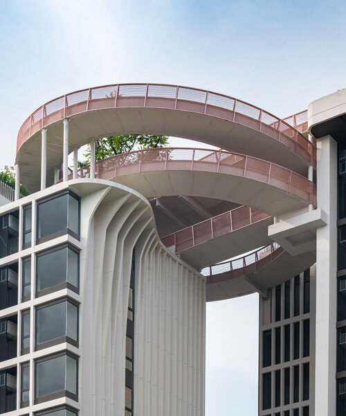 openbox architects inserts rose gold spiral ramp between two residential towers in bangkok