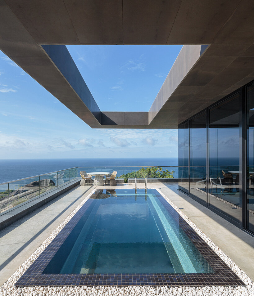 four angular holiday homes nestle into granite outcrops in the seychelles