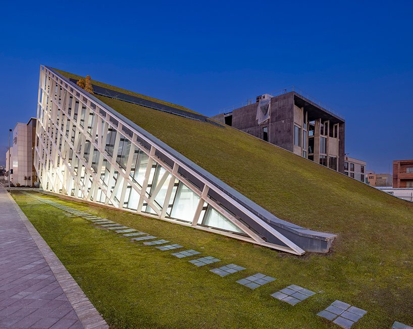 this new office and incubator building in tehran rises dramatically from the ground