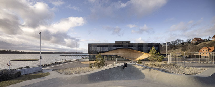 3XN honors denmark's ship-building heritage with the fluid facade of its 'klimatorium'