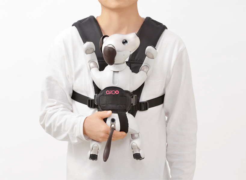 sony’s puppy robot can now be carried with its new sling that resembles a baby carrier
