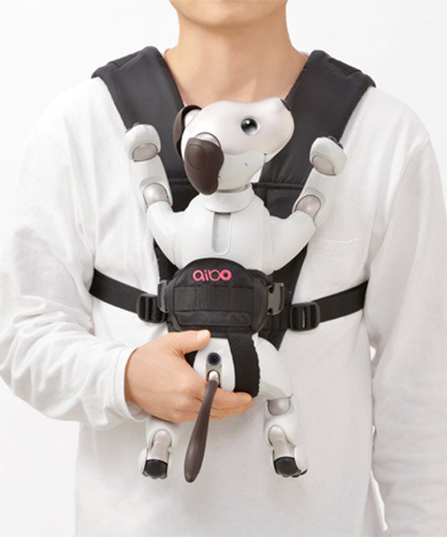 sony’s puppy robot can now be carried with its new sling that resembles a baby carrier